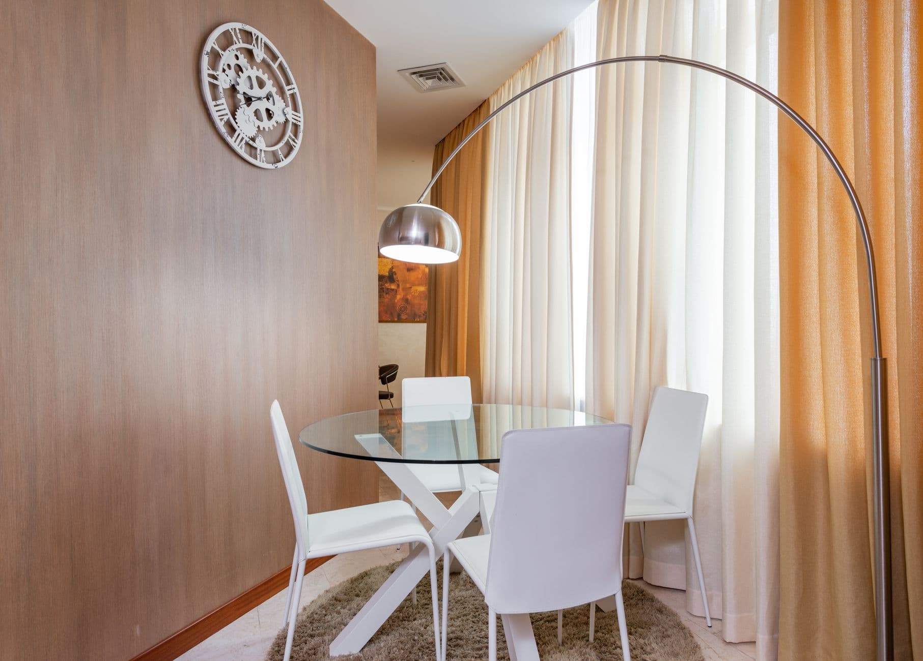 Modern apartment with a glass-topped round table and open space around it