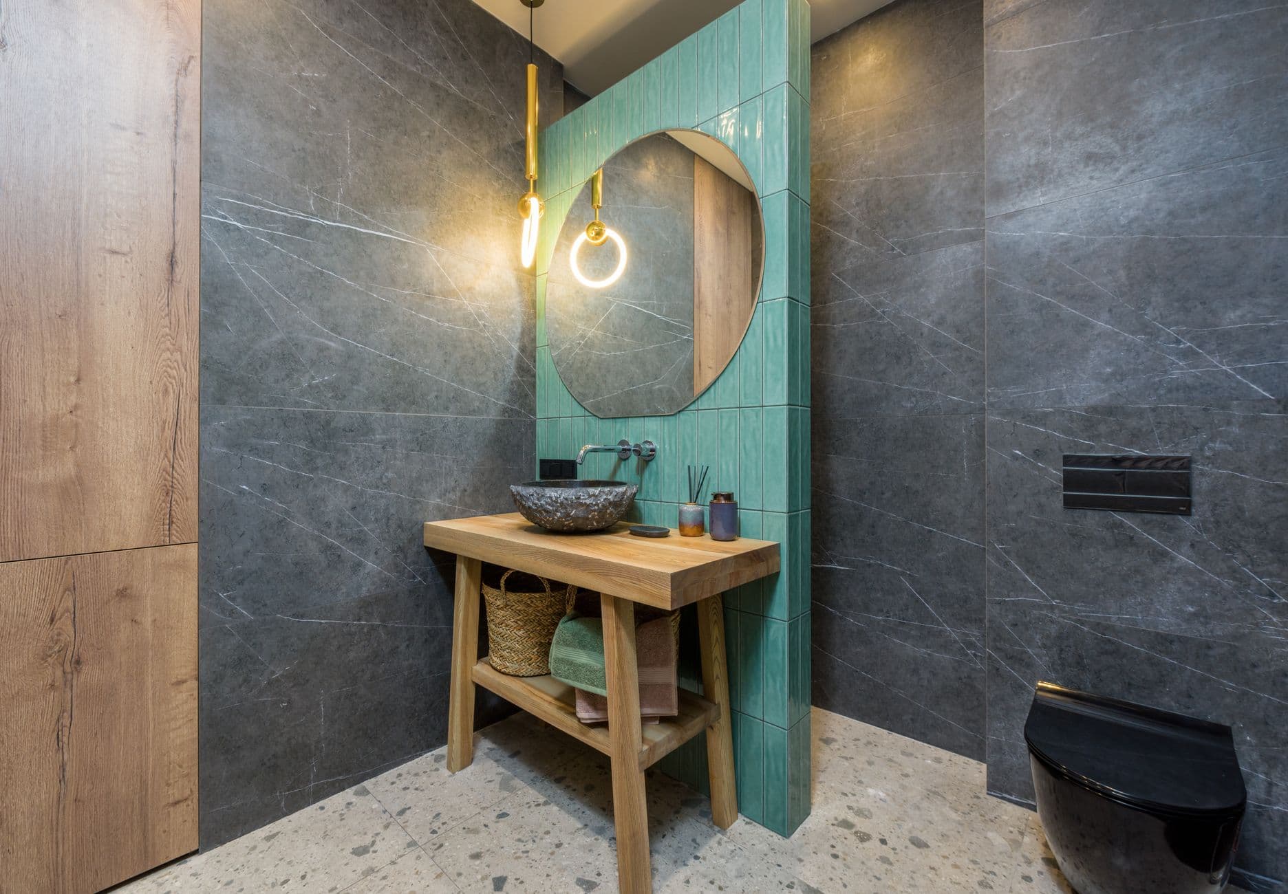 Bathroom wall with handleless storage panels beside a compact vanity
