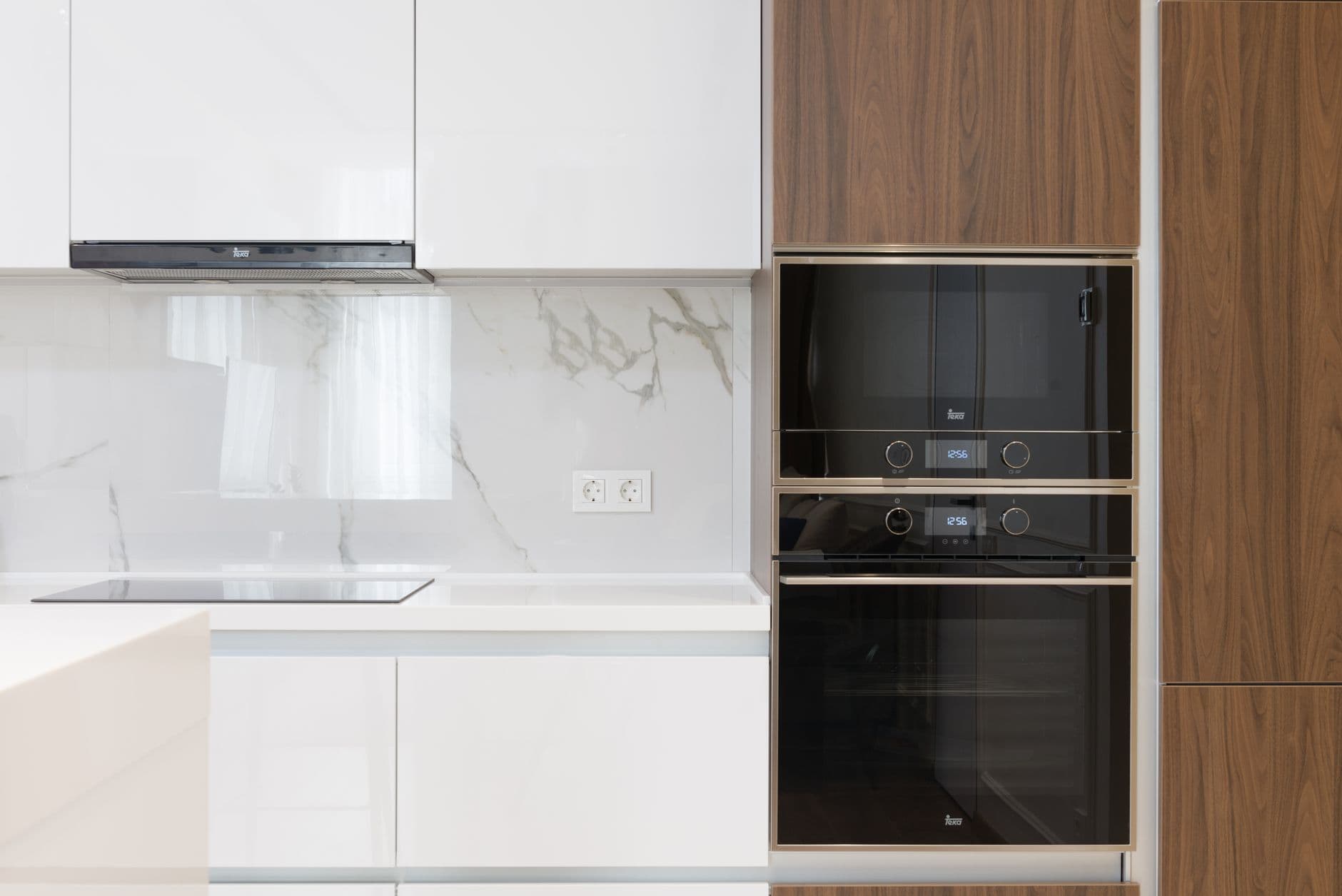Contemporary kitchen with a full wall of tall cabinets and integrated appliances
