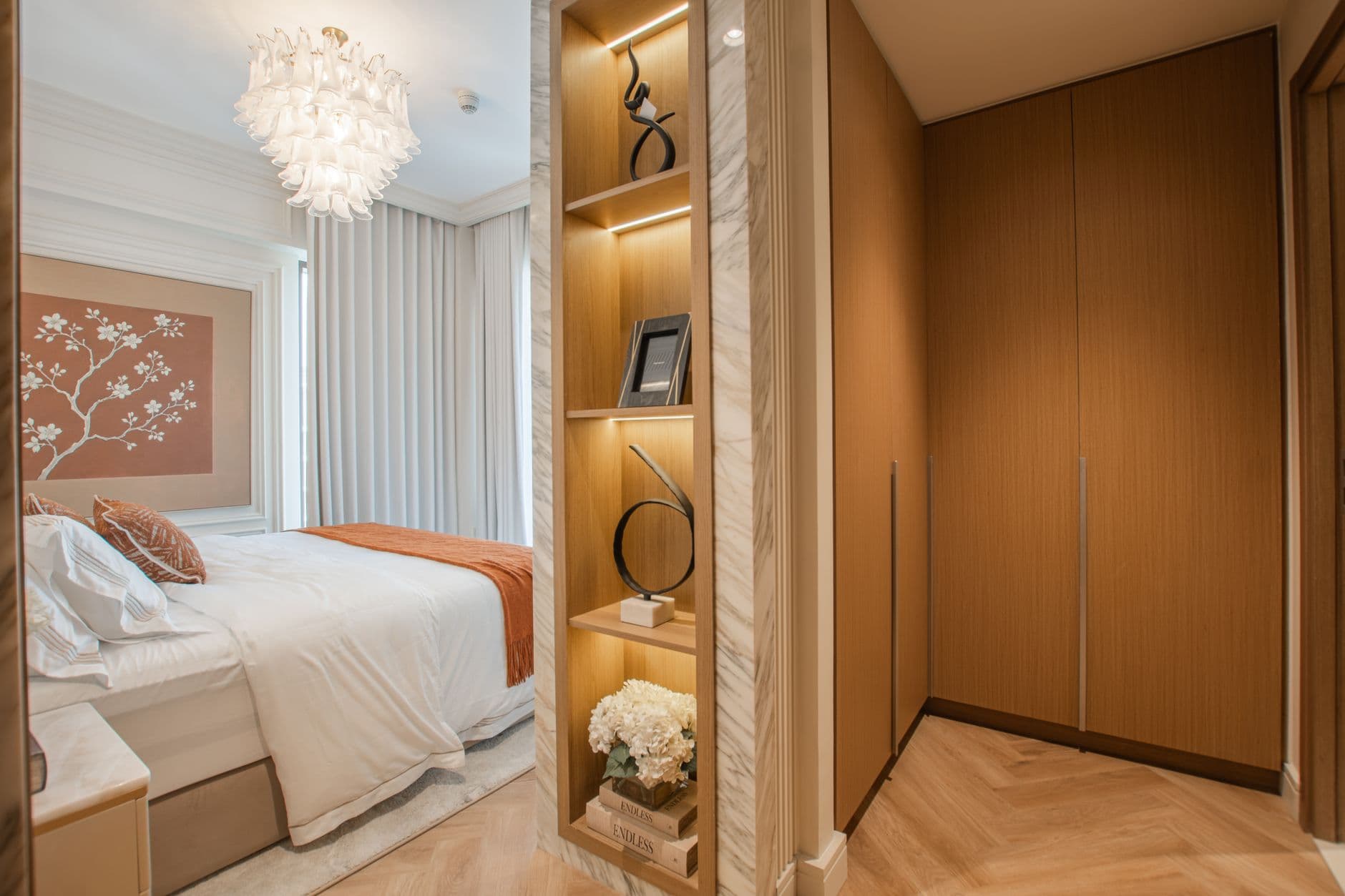 Bedroom with a full-height timber headboard wall and integrated bedside lights