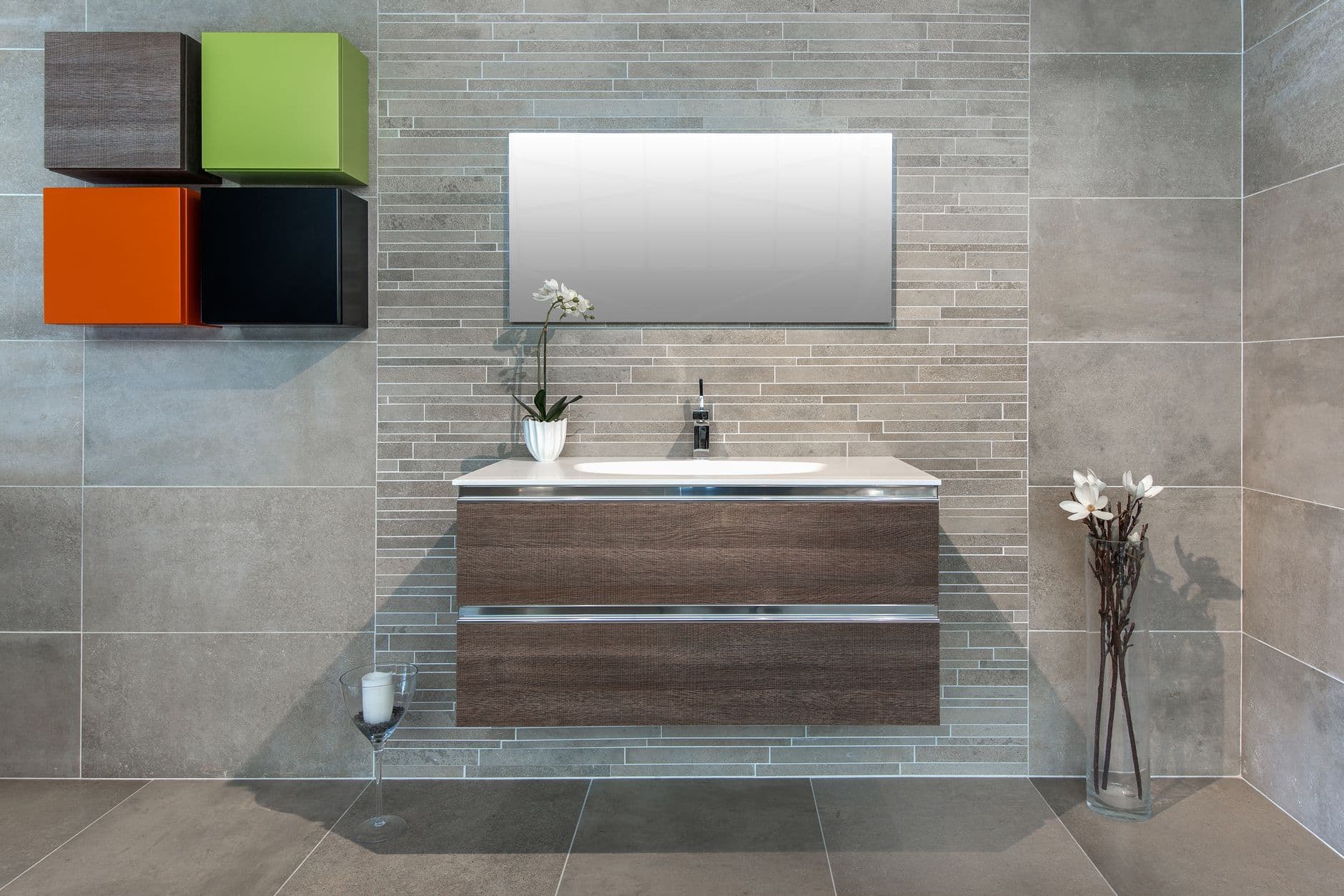 Warm timber vanity mounted against a cool grey stone bathroom wall