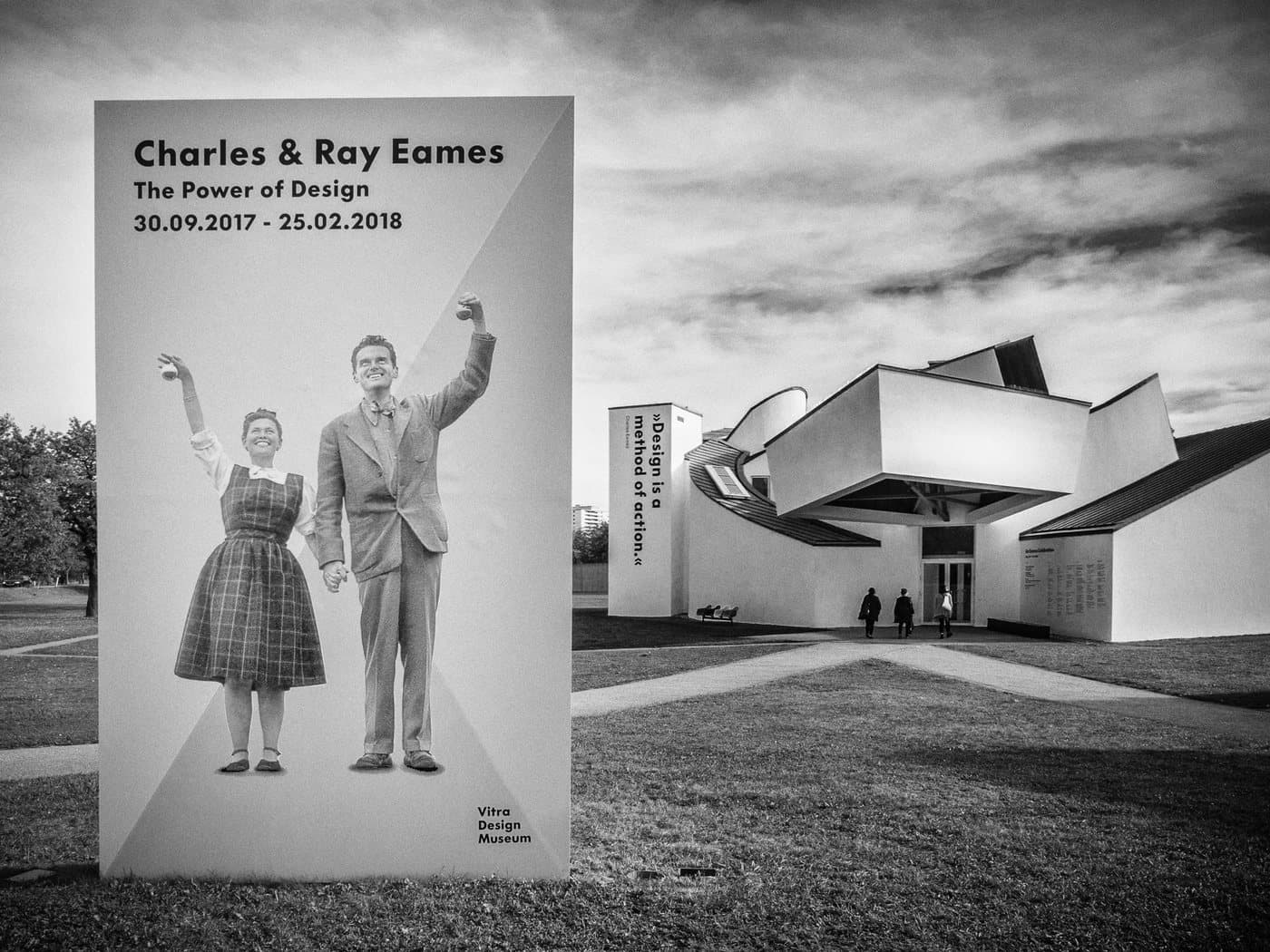 Exhibition poster depicting Charles and Ray Eames together