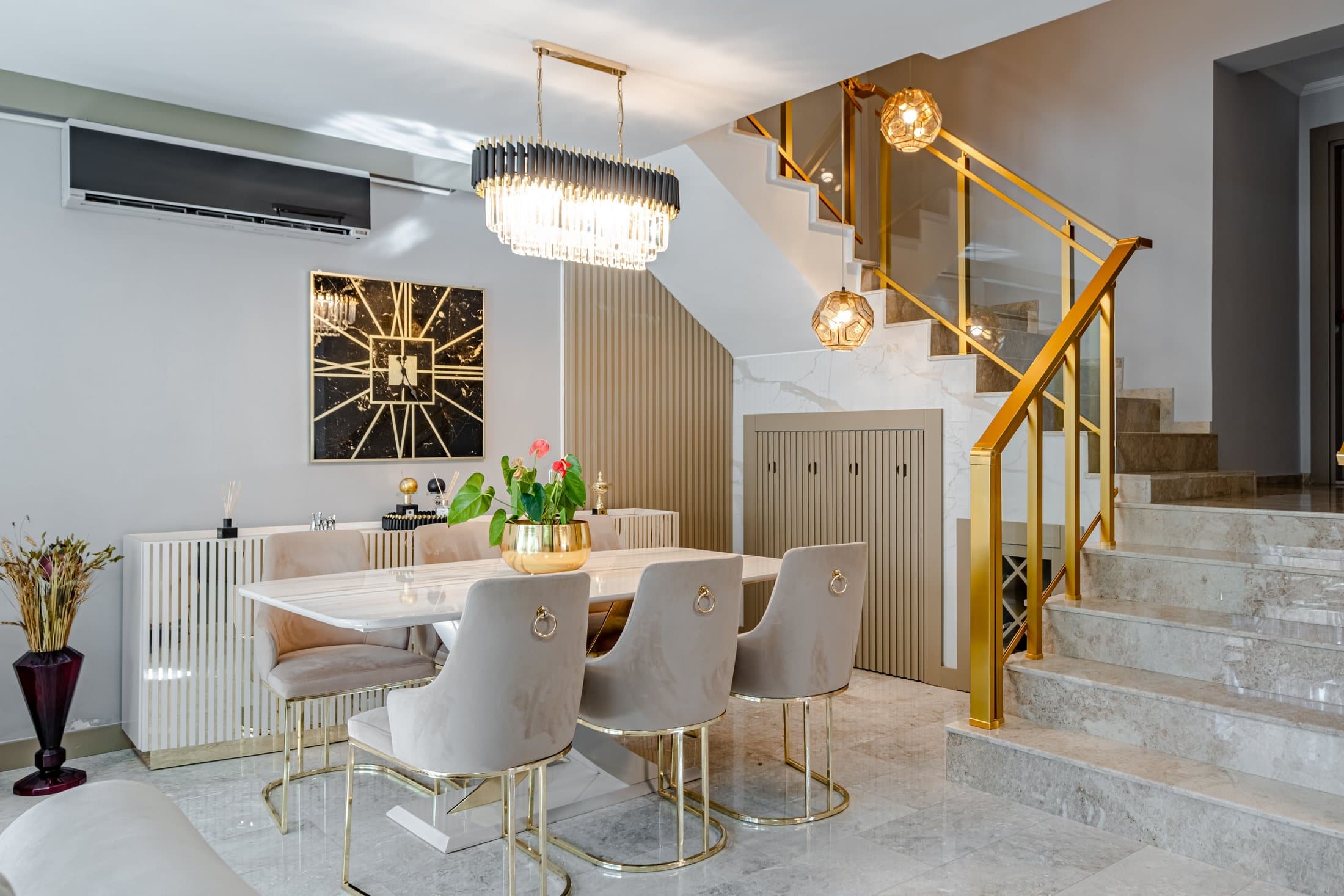 Dining room with warm metal chandeliers above the table