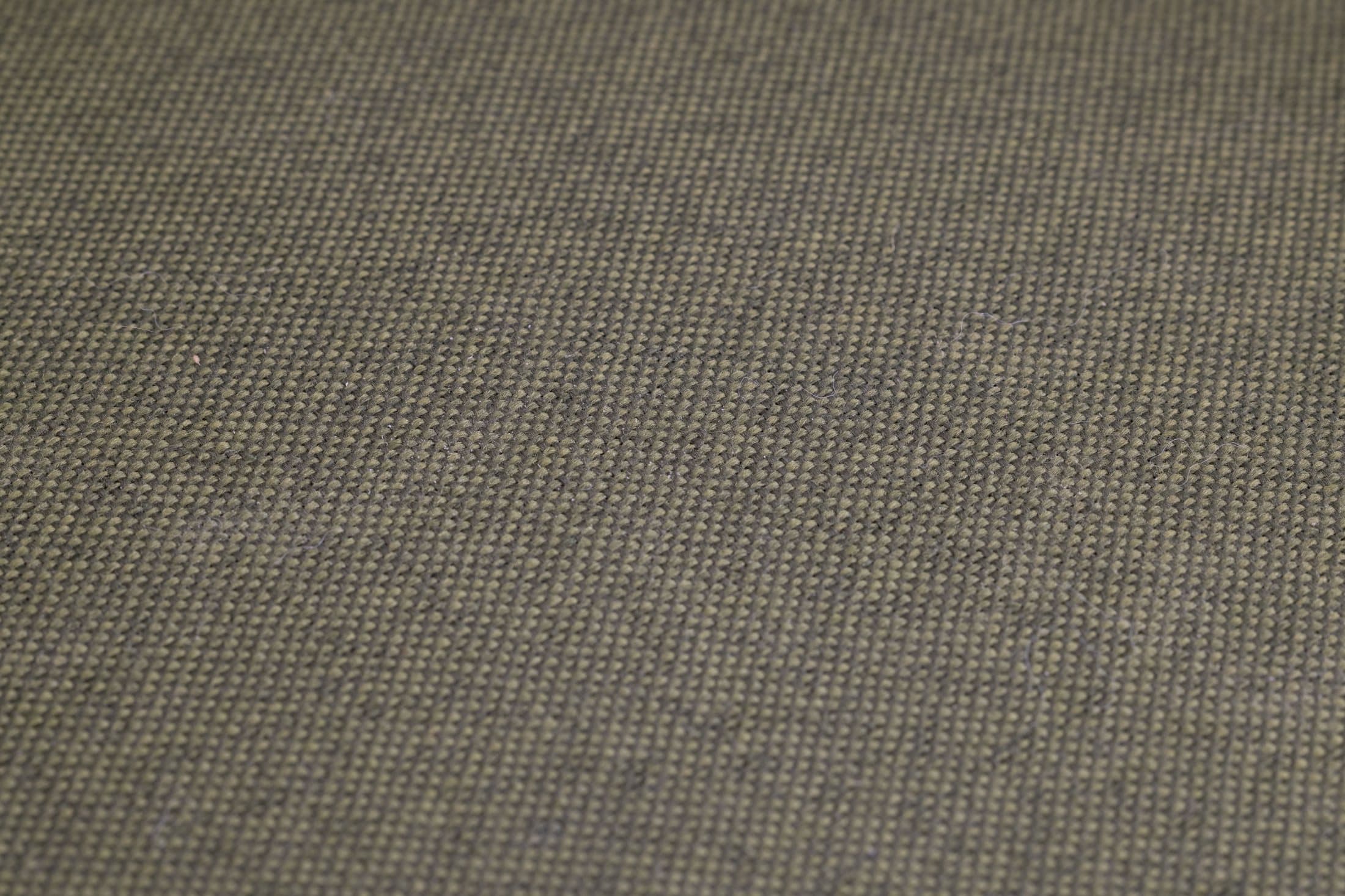 Close view of densely woven olive-brown upholstery fabric